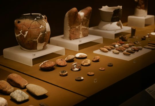 a table topped with lots of vases and rocks