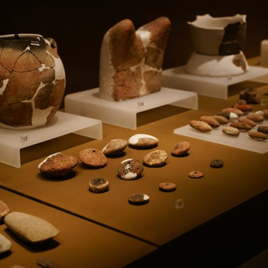 a table topped with lots of vases and rocks
