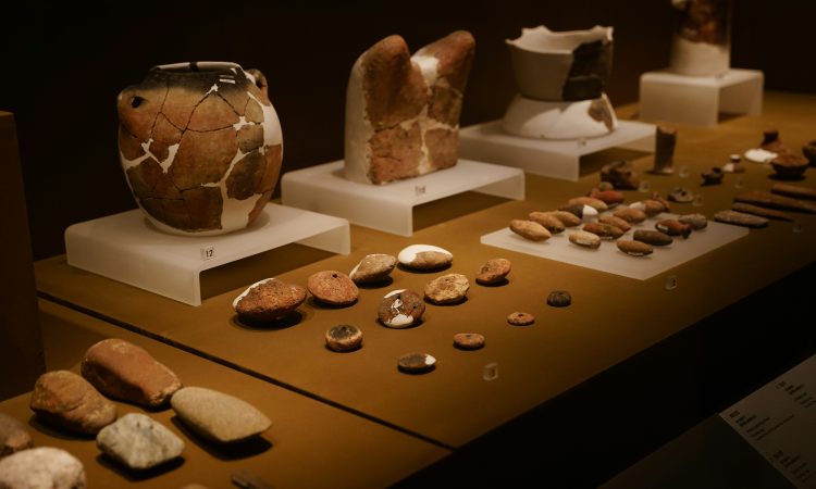 a table topped with lots of vases and rocks