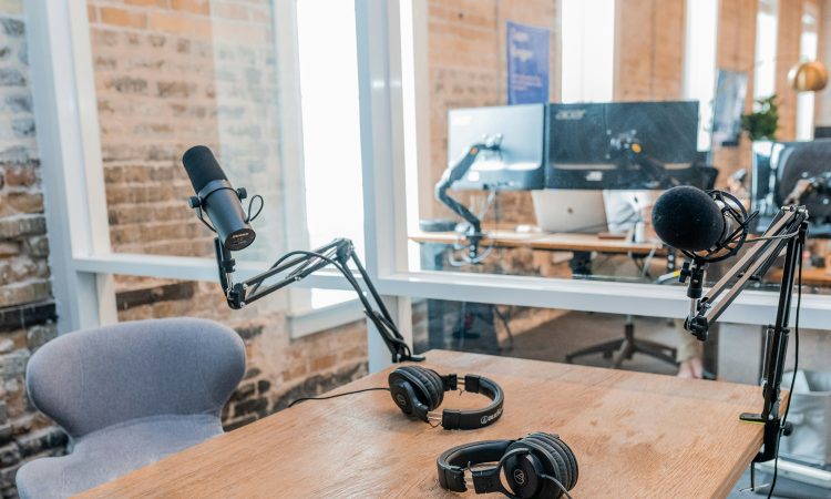 two black headphones on brown wooden table